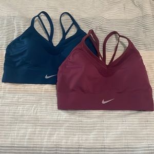 Two strappy Nike Sports bras size M blue and purple. This listing is for both.